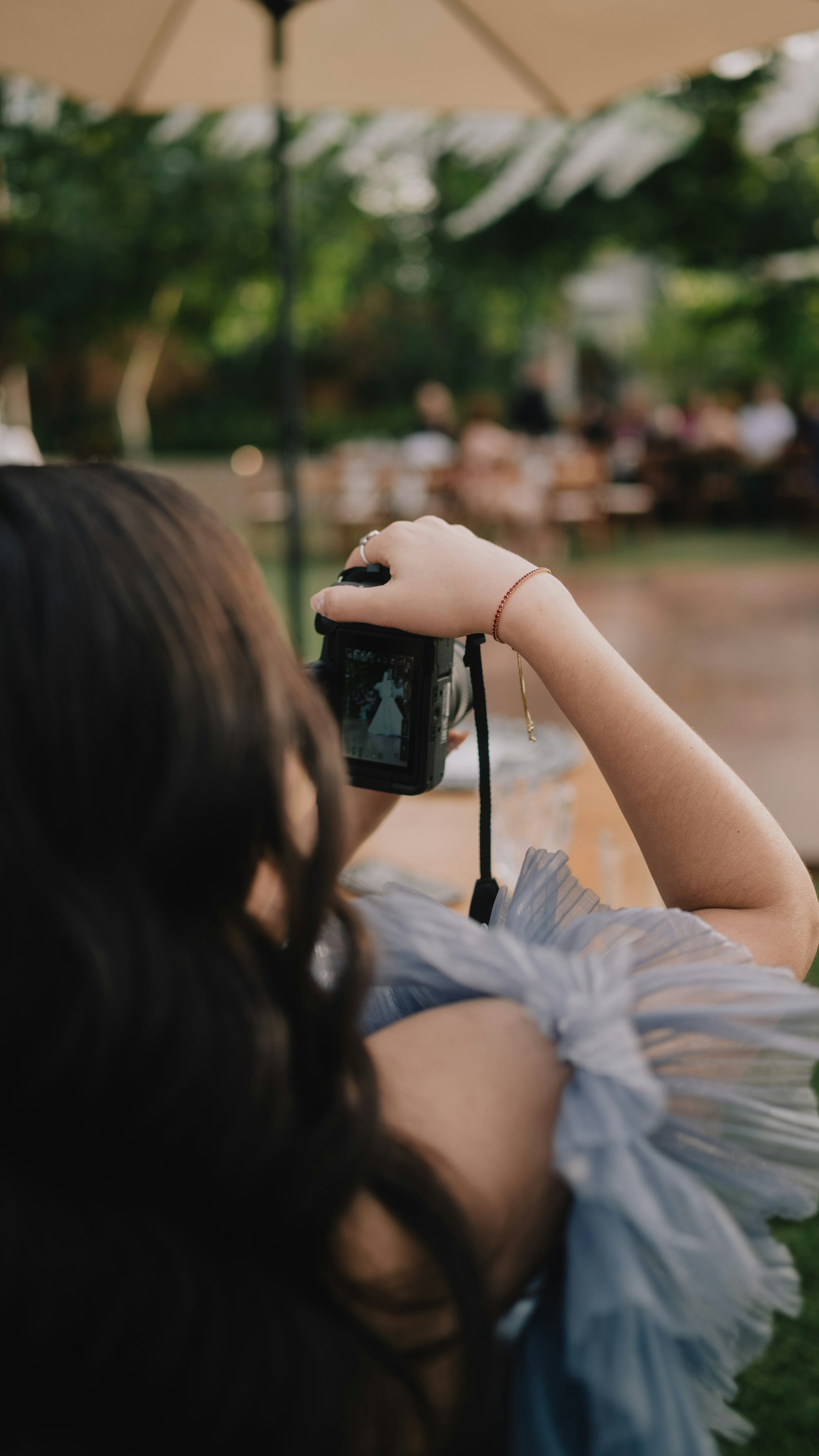 Creator with a camera photographing a bride at a wedding