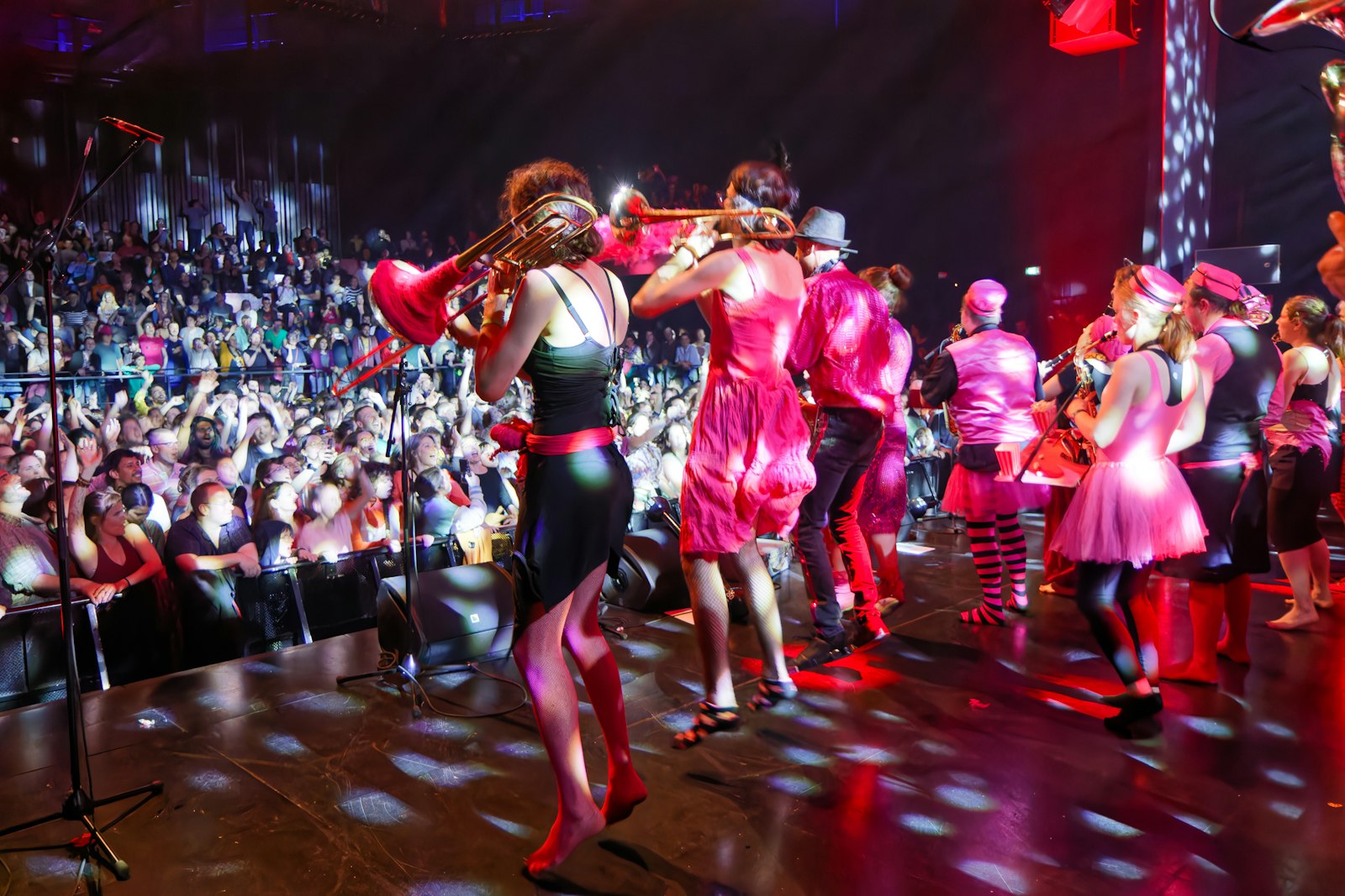 Musicians performing on stage for a large audience