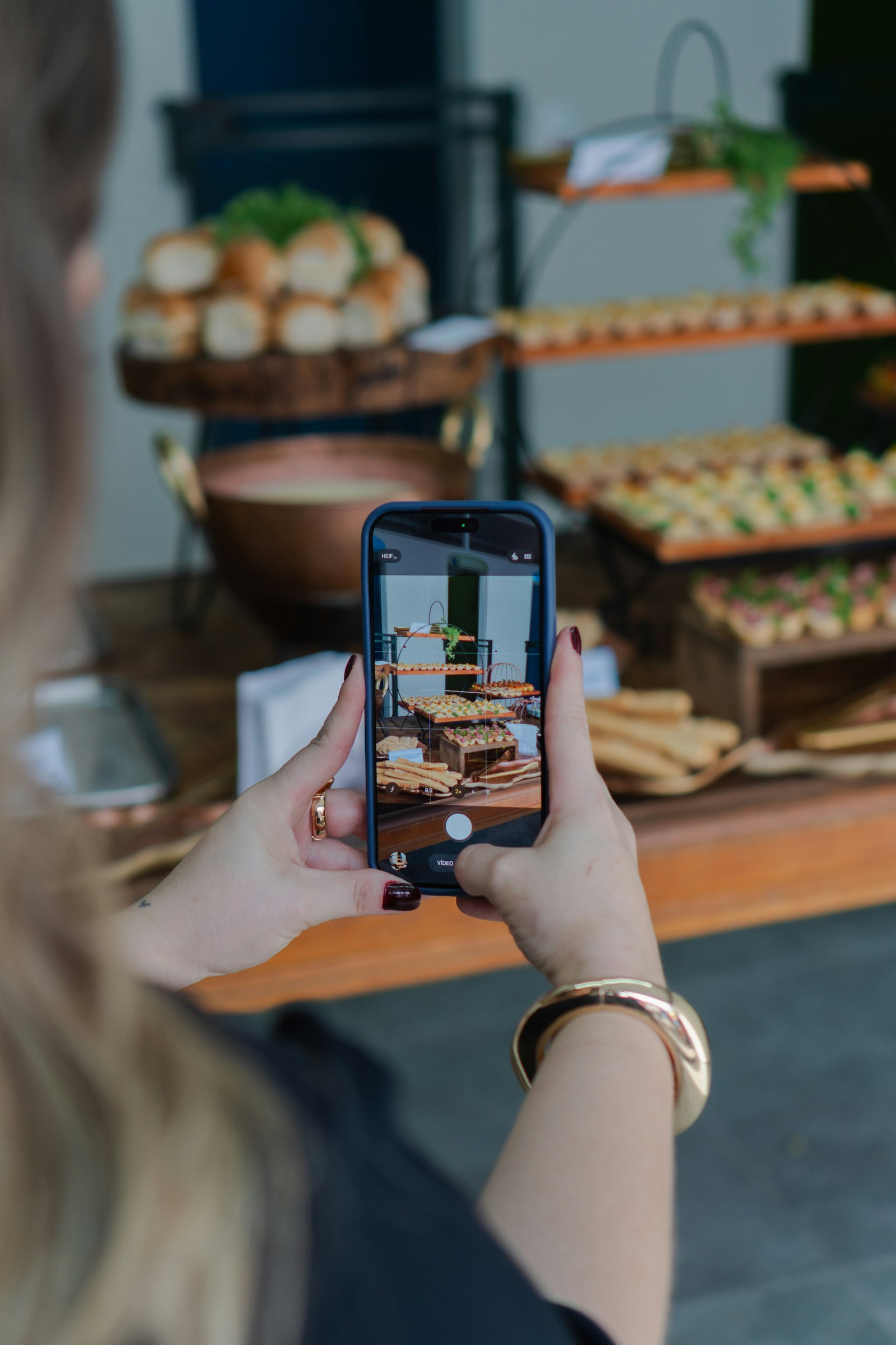 Creator photographing a buffet spread